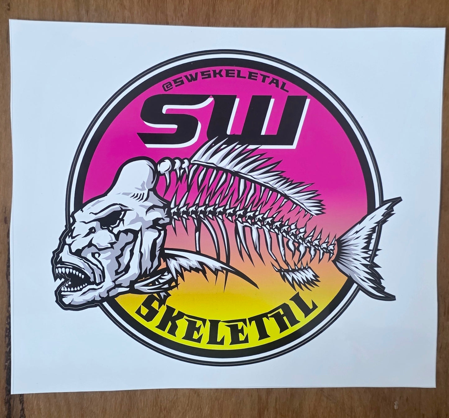 Sticker with fish skeleton design and 'SWSKELETAL' branding on a white background